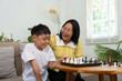© Natee Meepian - Activity with mother and son playing chess at home
