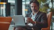 © sitifatimah - Caucasian businessman relaxes holding coffee laptop, exuding confidence, projecting success professional setting.