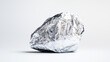 © Shahidul  studio - Photo of a rock covered in aluminum foil on a white background. Web banner with copy space to the right