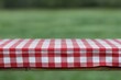 © firdan - Red and White Gingham Tablecloth on Wood Surface