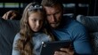 © khumthong - Father and Daughter Sharing a Tablet Together at Home Cozy Evening Family Time