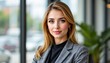 © Angelo - Professional portrait of a young businesswoman in a modern office setting capturing confidence and style