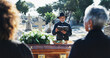 © peopleimages.com - Bible, coffin and pastor by graveyard with people for spiritual farewell, grief or loss. Religion, casket and priest with family for memorial service at burial with holy book for blessing or goodbye.