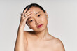 © LIGHTFIELD STUDIOS - Captivating beauty of a young asian woman highlighting her radiant skincare routine at home