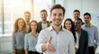 © schiers_images - Friendly business team leader extending a hand for a handshake, surrounded by supportive colleagues, reflecting collaboration and professional teamwork in a modern corporate environment.