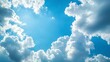 © ArmStrong☠ - Bright sun shining through fluffy white cumulus clouds in a vivid blue sky.