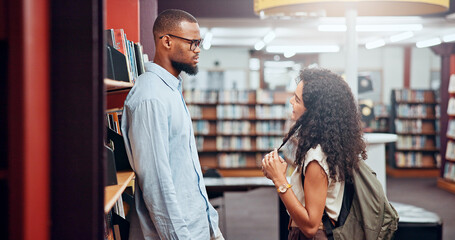 Poster - Couple, talking or man with woman in library for dating, college education and chat on break. University, interracial and students flirting in campus for learning, relationship and studying together