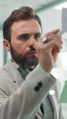 Poster - Glass wall, sticky notes and writing with business man in office for brainstorming or strategy. Ideas, mind map and planning with professional employee at work for creative development or design