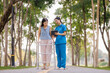 © Wanchai - Amid the calming greenery of the hospital’s garden, a caring female physician provides thoughtful consultation and guidance on treatment for her patient.