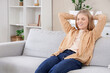 © Pixel-Shot - Young blonde woman resting on sofa at home