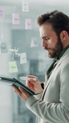 Poster - Glass wall, problem solving and tablet with business man in office for brainstorming or strategy. Mind map, reading and sticky notes with employee in workplace for creative development or design