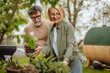 © Miljan Živković - Happy mature senior couple gardening together in a green space