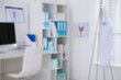 © New Africa - Blurred view of doctor's workplace in office