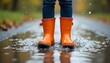 © Umair - Woman wearing yellow rain boots splashing in a puddle during a vivid autumn sunset, created with generative ai
