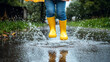 © jainul - Child in Yellow Rain Boots and Umbrella Leaping into Street Puddles, Water Splashing Everywhere