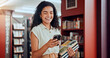 © Jessy/peopleimages.com - Woman, phone and books with texting at library with smile, contact and excited with studying at college. Girl, person and university student with smartphone, mobile app or social media at academy