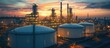© adiba - Oil refinery at sunset, industrial complex, night time activity, aerial view, stock photo