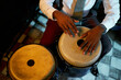 © Seventyfour - Cropped shot of male musician wearing suit with tie playing beat on traditional conga drums, while performing Afro Cuban jazz music in bar