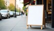 © Rama - Front view mockup of blank standing restaurant menu board on sidewalk, urban background, daylight scene