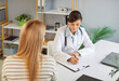 © Studio Romantic - Young woman patient talking to female doctor in office during medical examination. Woman physician listening to the patient's complaints in clinic. Healthcare and medicine concept.