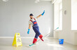 © Studio Romantic - Professional dancing funny cleaning worker, cleaner, janitor wearing blue protective rubber gloves, uniform, holding mop, domestic or commercial cleaning, washing for household, work in building