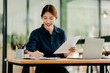 © Daenin - Young Asian woman doing financial accounting and taxes for a company Organizing account analysis reports Investment information Financial and tax system concepts