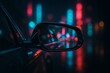 © Maksim - A rainy night cityscape reflected in a car's side mirror, with colorful neon lights creating a cinematic and moody urban atmosphere.