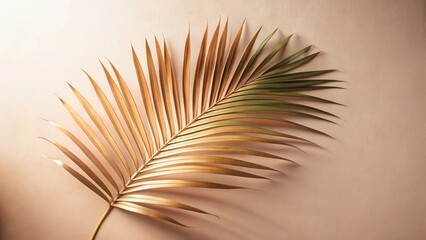 Aufkleber - A single, elegant palm frond with golden hues rests on a soft, neutral background, showcasing its delicate texture and graceful form.