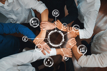 Poster - A diverse group of hands united in collaboration above a circular interface, symbolizing teamwork and innovation in a modern business environment. Amity