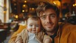 © ek - Joyful father and baby sharing a warm moment in a cozy café