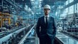 © Abdul - Engineer in suit and hard hat standing in factory with digital overlay of blueprints and data visualization