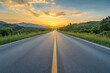 © Khozainuz - Serene road stretching towards the horizon under a vibrant sunset landscape