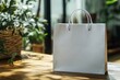 © Rochilah - A blank shopping bag mockup placed on a wooden table