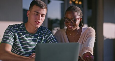 Fototapete - University student, couple and laptop at campus, study and talk for review, research or studying. People, computer or writing notes with learning, education or interracial with scholarship at college
