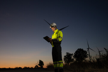 Aufkleber - Engineer man working with tablet at windmill farm Generating electricity clean energy. Wind turbine farm generator by alternative green energy.