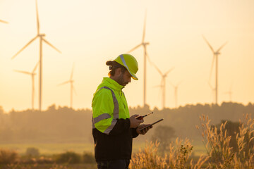Aufkleber - Engineer man working with tablet at windmill farm Generating electricity clean energy. Wind turbine farm generator by alternative green energy.