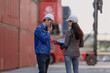 © Nassorn - Foreman worker wear safety hardhat standing inspecting container cargo at warehouse storage terminal. Industrial engineer woman working at import export distribution port. Diverse people work together