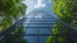 © Thanthara - modern office tower with reflective glass windows surrounded by lush green trees, creating