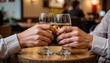 © Nattapol - Cheers with glasses of wine at a cozy table.