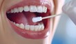 © Olga Gorkun - A close-up view of a healthcare professional collecting a DNA sample by swabbing the inside of a person's mouth in a clinic