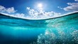 © Fbio - half underwater shot of the sea with cloudy sky turquoise water sun glare and bubbles forming a calming ocean landscape