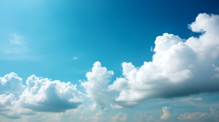 Leinwandbilder - A wide-angle upward shot captures a vast blue sky adorned with fluffy white clouds, showcasing natural light and clear atmospheric perspective, ideal for inspiration
