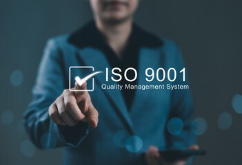 Poster - ISO 9001 Quality Management System Concept. Businesswoman pointing to ISO 9001 quality management system icon, representing certification standards, business excellence, ISO certified, standardization