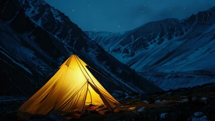 Wall Mural - a small yellow tent is set up in the snow on a mountain. the sky is dark and the stars are shining b