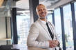 © peopleimages.com - Smile, business or portrait of mature man in lobby for career success, expert or comfort in building. Pride, male accountant or happy for economic growth for profit, investment or finance in New York