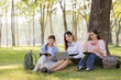 © Wanchai - A group of female students sits under a tree in the park, laughing and chatting joyfully together.