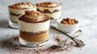 © Anat art - Delicious Tiramisu Served in Elegant Glass Cups on a Marble-White Background Showcasing Artistic Food Presentation