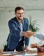 © Lumos sp - young business people meeting office handshake hand shake shaking hands teamwork contract agreement partnership introduction greeting businessman man introducing businesswoman black applause