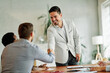 © Lumos sp - young business people meeting office handshake hand shake shaking hands teamwork  contract agreement black happy smiling success partnership introduction greeting businessman man introducing