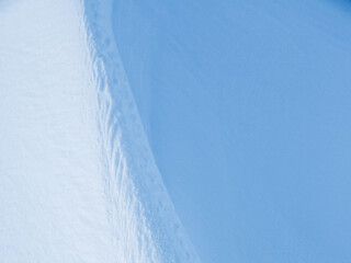 Wall Mural - snow texture. wind sculpted patterns on snow surface. wind in the tundra and in the mountains on the
